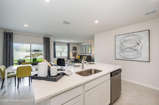 kitchen featuring a sink, visible vents, dishwasher, open floor plan, and white cabinets