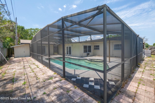 315 Cherry Ave, Merritt Island, FL 32953 - back of house featuring a patio, a storage unit, an outdoor structure, glass enclosure, and fence