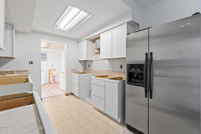315 Cherry Ave, Merritt Island, FL 32953 - kitchen with stainless steel refrigerator with ice dispenser, open shelves, white cabinets, light countertops, and a sink