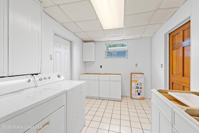 315 Cherry Ave, Merritt Island, FL 32953 - laundry area with washing machine and clothes dryer, light tile patterned floors, and cabinet space