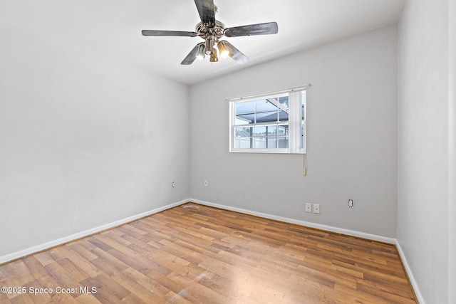 315 Cherry Ave, Merritt Island, FL 32953 - empty room with wood finished floors, baseboards, and a ceiling fan
