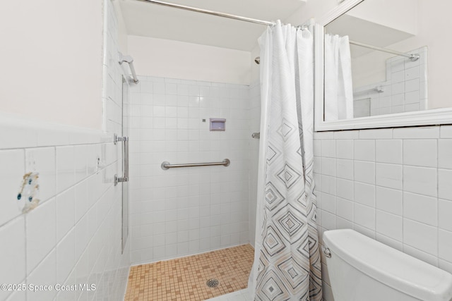 315 Cherry Ave, Merritt Island, FL 32953 - full bathroom with tile walls, a shower stall, and toilet