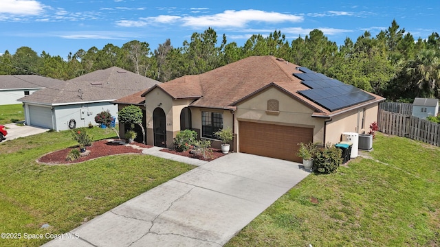 249 Franzing St, Palm Bay, FL 32908 - view of front of house with stucco siding, a garage, concrete driveway, solar panels, and central AC
