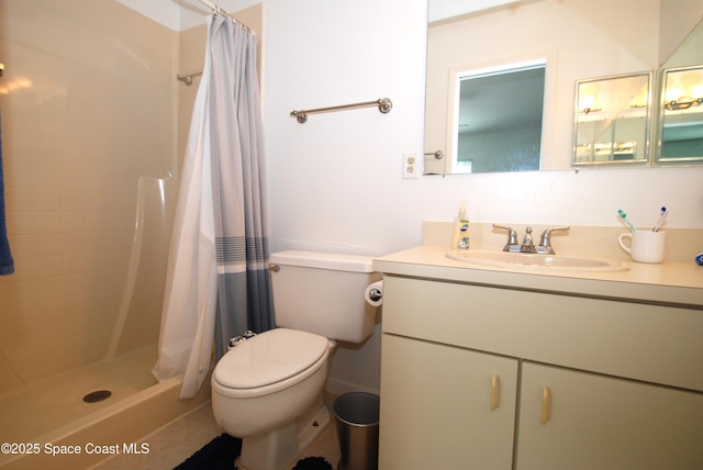 full bathroom with toilet, vanity, and a stall shower