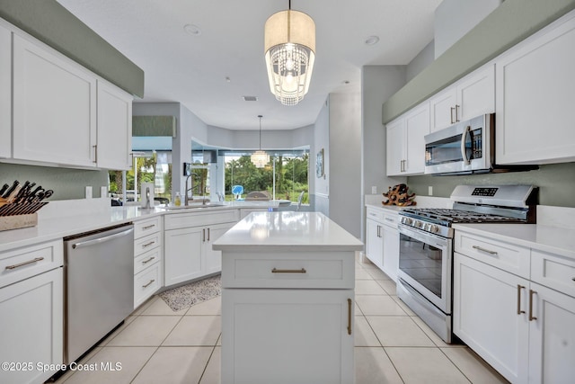 4220 Savannahs Trl, Merritt Island, FL 32953 - kitchen with stainless steel appliances, a sink, a chandelier, a center island, and light countertops