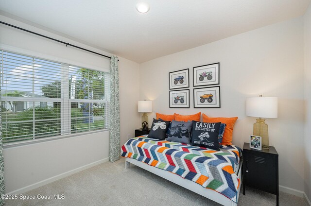 carpeted bedroom featuring baseboards