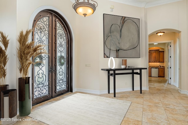 7346 Gorda Peak Ct, Melbourne, FL 32940 - entryway featuring arched walkways, french doors, baseboards, and ornamental molding