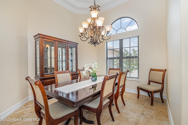 7346 Gorda Peak Ct, Melbourne, FL 32940 - dining space featuring ornamental molding, a chandelier, a towering ceiling, and baseboards