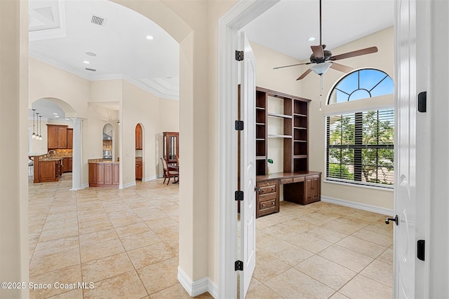 7346 Gorda Peak Ct, Melbourne, FL 32940 - hall featuring arched walkways, light tile patterned floors, a towering ceiling, ornamental molding, and recessed lighting