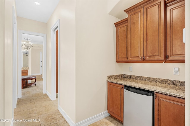 7346 Gorda Peak Ct, Melbourne, FL 32940 - bar area featuring refrigerator, a chandelier, baseboards, light tile patterned flooring, and recessed lighting