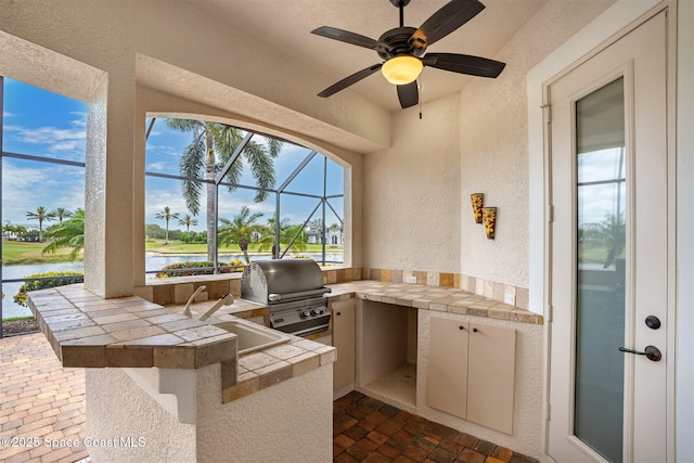 7346 Gorda Peak Ct, Melbourne, FL 32940 - view of patio / terrace with area for grilling, a lanai, a sink, and a water view