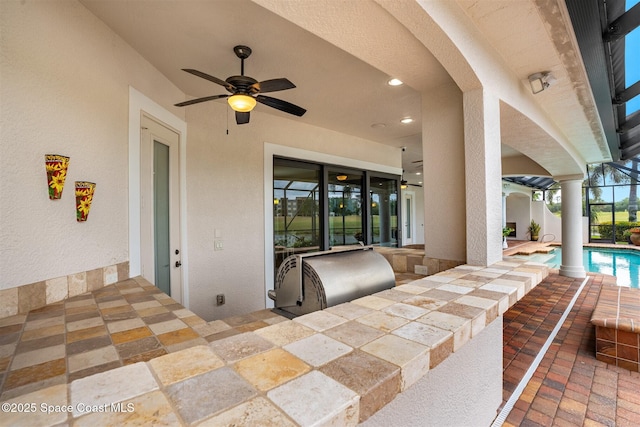 7346 Gorda Peak Ct, Melbourne, FL 32940 - view of patio featuring an outdoor kitchen, ceiling fan, an outdoor pool, and a lanai