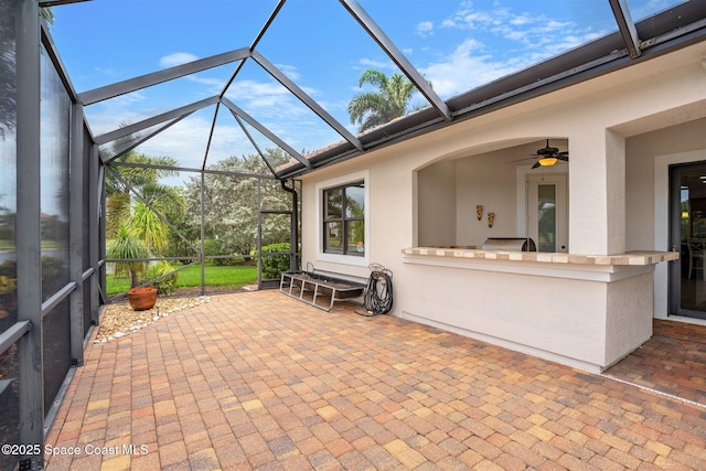 7346 Gorda Peak Ct, Melbourne, FL 32940 - view of patio featuring exterior kitchen, glass enclosure, and ceiling fan