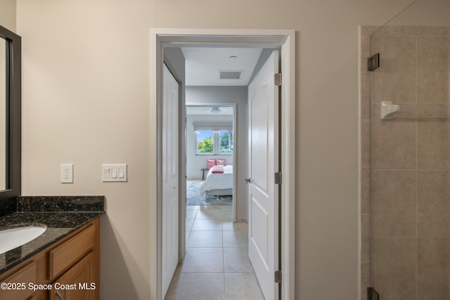 bathroom featuring ensuite bath, visible vents, tile patterned flooring, tiled shower, and vanity