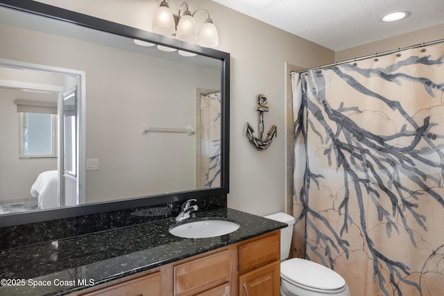 full bath featuring vanity, toilet, a textured ceiling, and recessed lighting