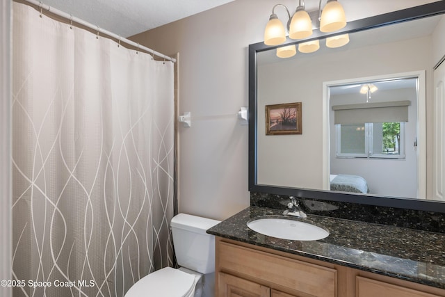 ensuite bathroom with vanity, toilet, and ensuite bathroom