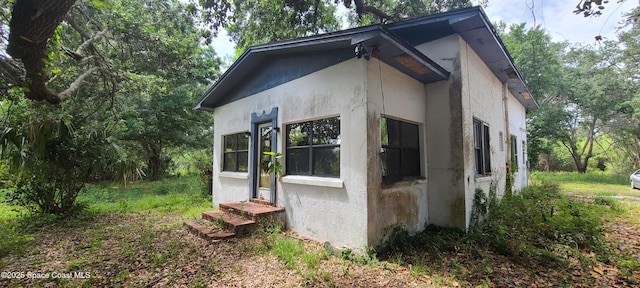 920 Malabar Rd, Malabar, FL 32950 - view of property exterior featuring stucco siding and entry steps