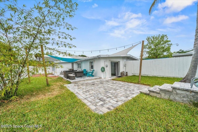 215 Jefferson Ave, Cape Canaveral, FL 32920 - rear view of property featuring a patio, an outdoor hangout area, and stucco siding