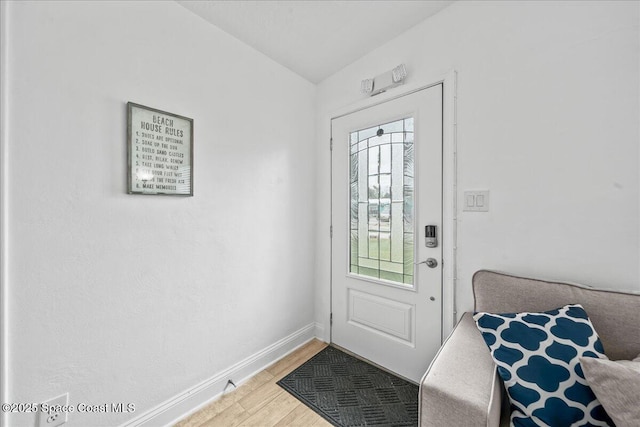 215 Jefferson Ave, Cape Canaveral, FL 32920 - foyer with light wood-type flooring, vaulted ceiling, and baseboards