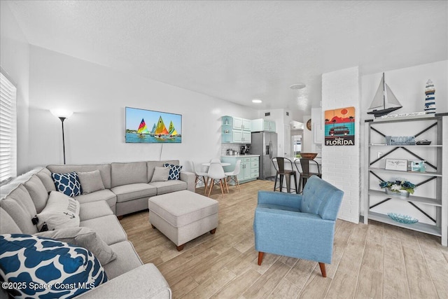215 Jefferson Ave, Cape Canaveral, FL 32920 - living room with light wood-type flooring, plenty of natural light, and a textured ceiling