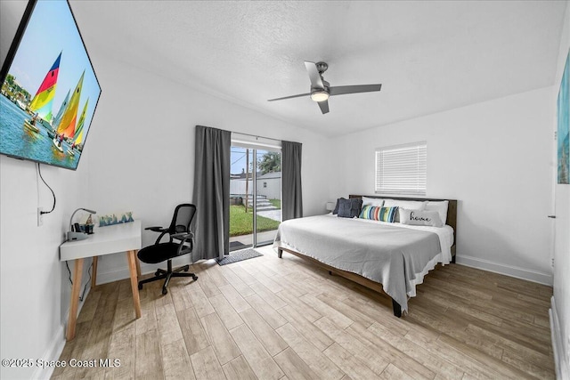 215 Jefferson Ave, Cape Canaveral, FL 32920 - bedroom featuring wood finished floors, access to outside, baseboards, a textured ceiling, and a ceiling fan