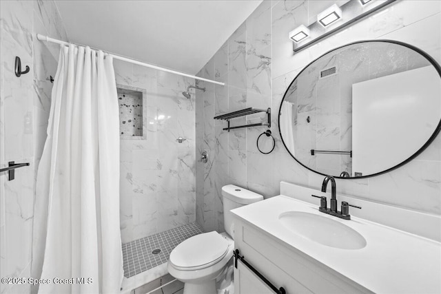 215 Jefferson Ave, Cape Canaveral, FL 32920 - full bathroom featuring vanity, a marble finish shower, toilet, and tile walls