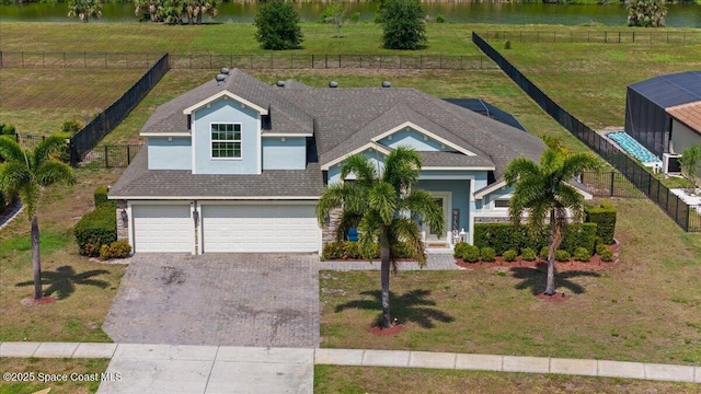 view of front of property with driveway, an attached garage, a shingled roof, and stucco siding