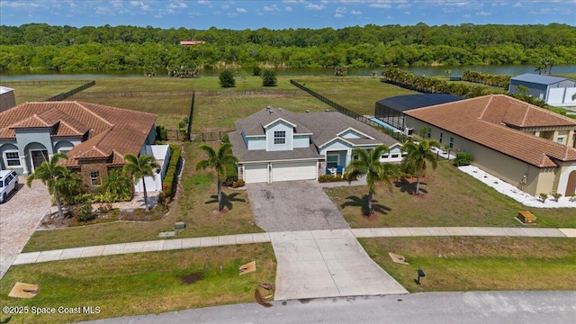aerial view of property and surrounding area featuring a nearby body of water