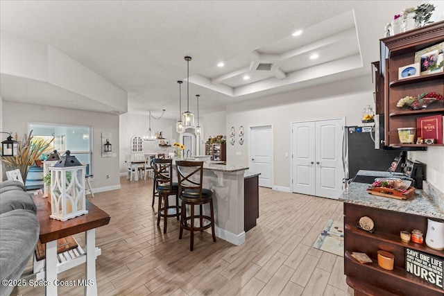 7268 Preserve Pointe Dr, Merritt Island, FL 32953 - kitchen with open shelves, light wood-style floors, recessed lighting, and a kitchen breakfast bar