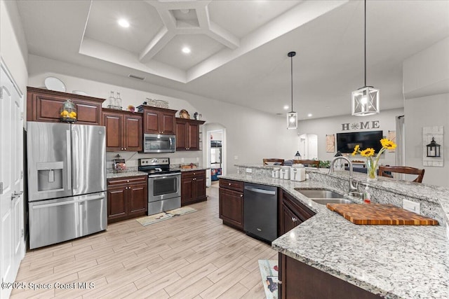 7268 Preserve Pointe Dr, Merritt Island, FL 32953 - kitchen featuring stainless steel appliances, a sink, arched walkways, light wood-style floors, and coffered ceiling
