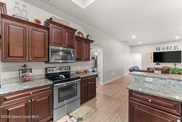 7268 Preserve Pointe Dr, Merritt Island, FL 32953 - kitchen with appliances with stainless steel finishes, arched walkways, baseboards, recessed lighting, and open floor plan