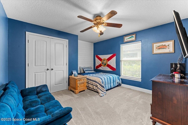 7268 Preserve Pointe Dr, Merritt Island, FL 32953 - bedroom with a closet, carpet flooring, a textured ceiling, ceiling fan, and baseboards
