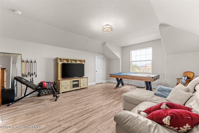 7268 Preserve Pointe Dr, Merritt Island, FL 32953 - rec room featuring lofted ceiling, light wood-style flooring, a textured ceiling, and baseboards