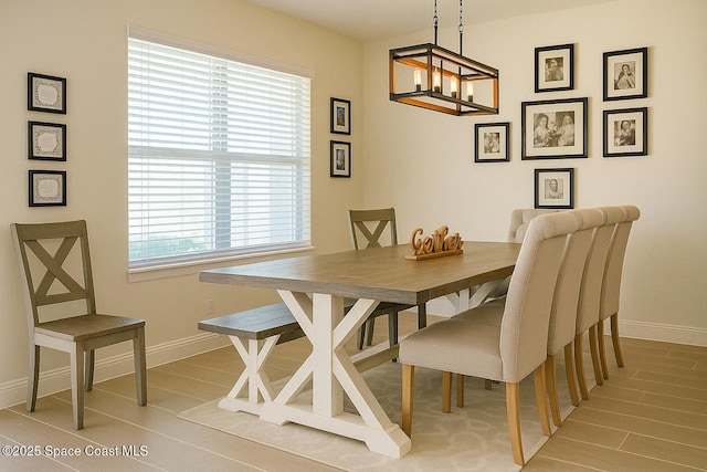 735 Sorrento Dr, Cocoa, FL 32922 - dining room with baseboards, a chandelier, and light wood-style floors