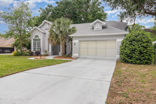 view of front of house with an attached garage, roof with shingles, a front lawn, driveway, and stucco siding