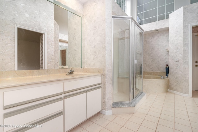 bathroom featuring tile patterned floors, a shower stall, vanity, wallpapered walls, and baseboards