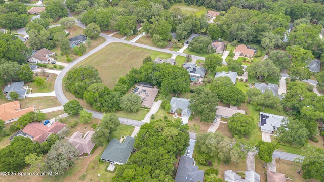 aerial view of property and surrounding area with nearby suburban area