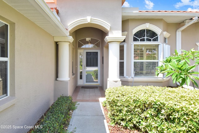 doorway to property with stucco siding
