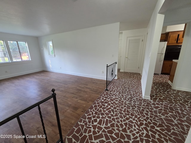 55 S Grandview Cir, Cocoa, FL 32922 - unfurnished living room featuring baseboards and wood finished floors