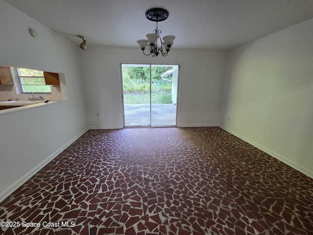 55 S Grandview Cir, Cocoa, FL 32922 - spare room featuring baseboards and a chandelier
