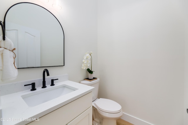 bathroom featuring toilet and vanity