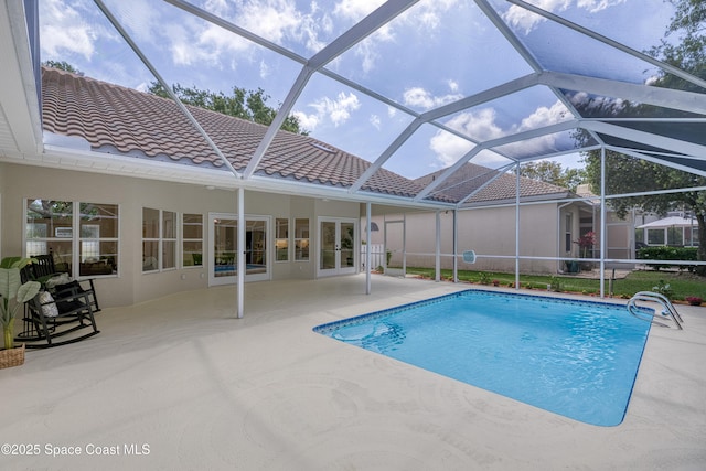 swimming pool with a patio, french doors, and a lanai