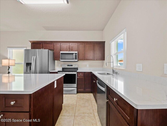 354 Dryden Cir, Cocoa, FL 32926 - kitchen with appliances with stainless steel finishes, a sink, light tile patterned flooring, and light countertops