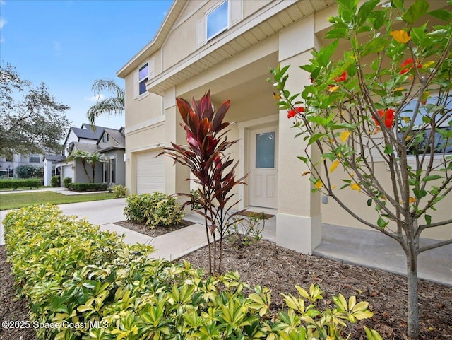 354 Dryden Cir, Cocoa, FL 32926 - view of side of property with a garage, stucco siding, and driveway