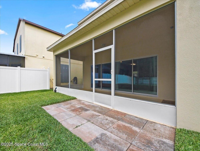 354 Dryden Cir, Cocoa, FL 32926 - rear view of house with a sunroom, a patio, and stucco siding