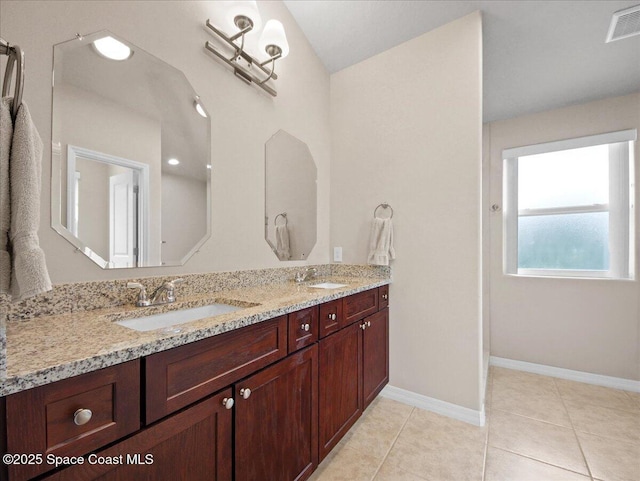 354 Dryden Cir, Cocoa, FL 32926 - bathroom with double vanity, baseboards, and tile patterned floors