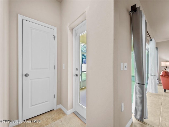 354 Dryden Cir, Cocoa, FL 32926 - doorway featuring baseboards and light tile patterned floors