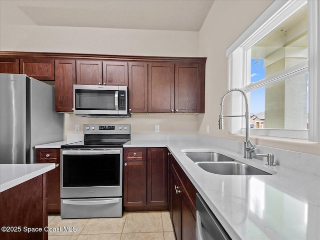 354 Dryden Cir, Cocoa, FL 32926 - kitchen featuring appliances with stainless steel finishes, a sink, light tile patterned flooring, and light stone counters