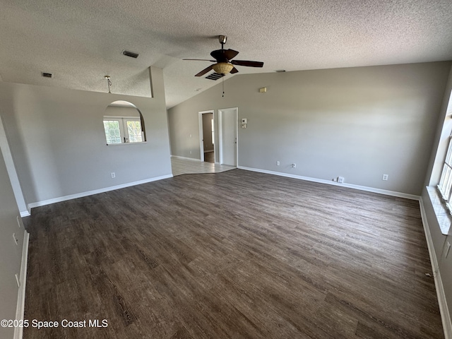 539 Olsmar St SW, Palm Bay, FL 32908 - spare room featuring ceiling fan, dark wood-type flooring, a textured ceiling, vaulted ceiling, and arched walkways