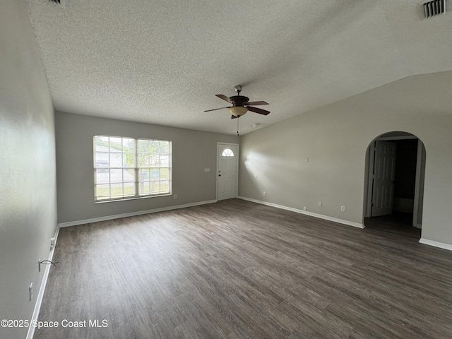 539 Olsmar St SW, Palm Bay, FL 32908 - spare room with a ceiling fan, arched walkways, dark wood-style flooring, a textured ceiling, and baseboards